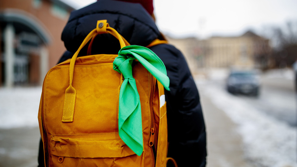 green bandana tied on backpack