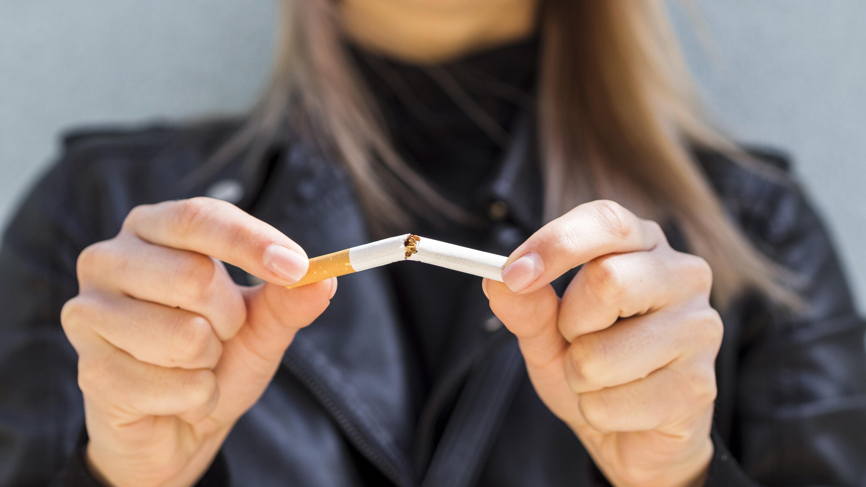 woman breaking cigarette