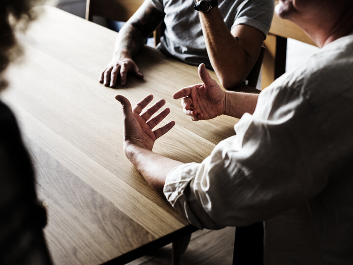 people around table talking