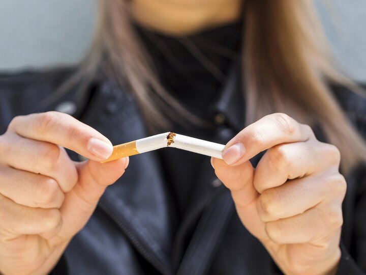 woman breaking cigarette